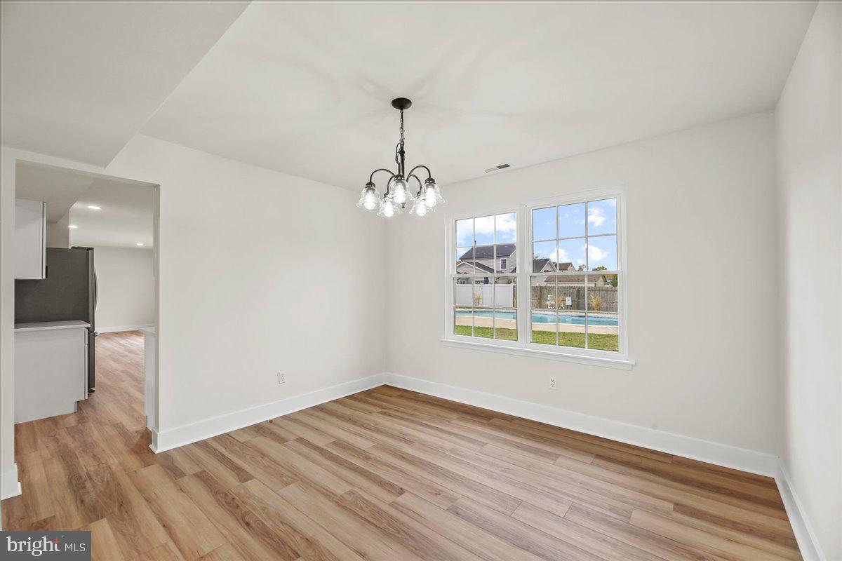 19 Intrepid Drive Sewell, NJ 08080 - Photo 7 of 47 a view of an empty room with wooden floor and a window