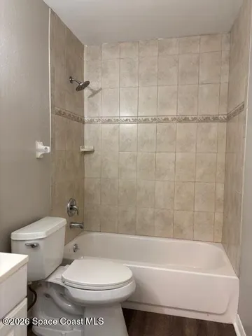 a bathroom with a toilet and a bathtub
