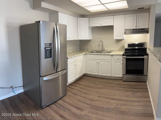 a kitchen with granite countertop stainless steel appliances and wooden cabinets