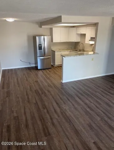 a kitchen with granite countertop a stove and a refrigerator