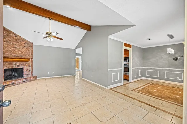 a view of an empty room with a fireplace