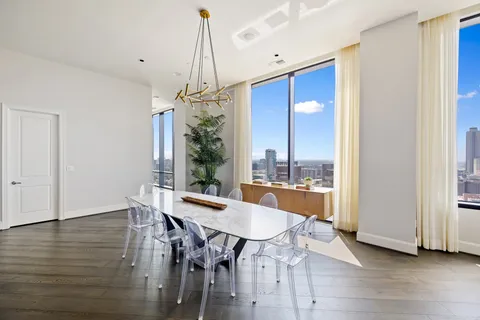 a living room with furniture and a chandelier