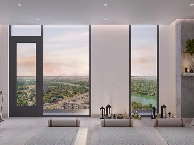 a living room with furniture and large windows