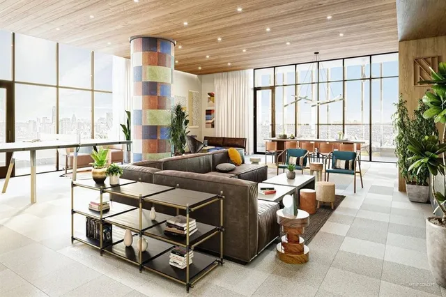 a living room with lots of furniture and a large window