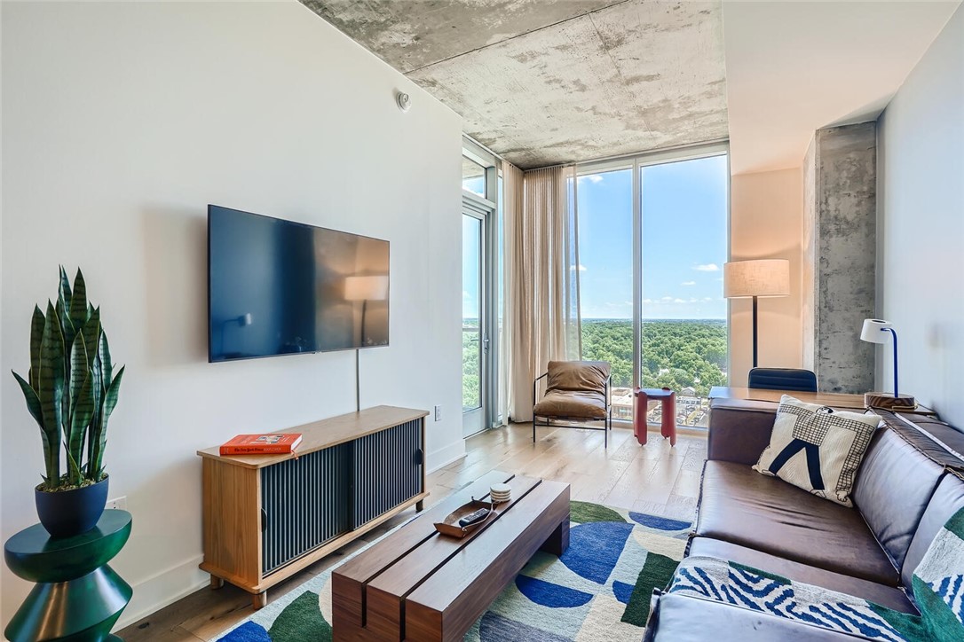 48 East Unit 1806 Avenue Austin, TX 78701 - Photo 2 of 20 a living room with furniture and a flat screen tv
