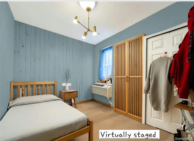 a bedroom with a bed and a chandelier