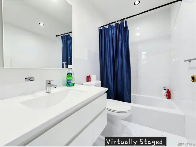 a bathroom with a sink a toilet and a large mirror
