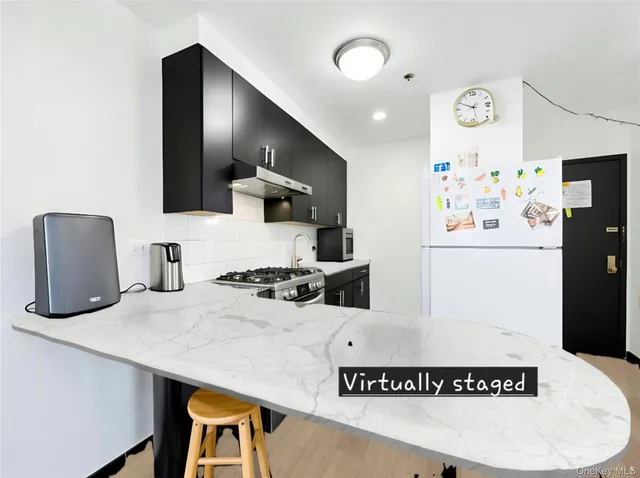 a kitchen with a refrigerator a stove a sink and a refrigerator