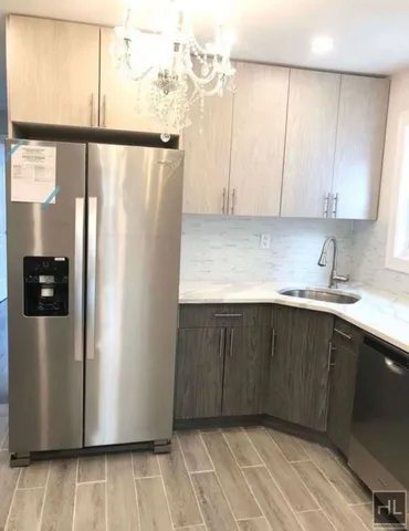 a kitchen with a refrigerator and cabinets