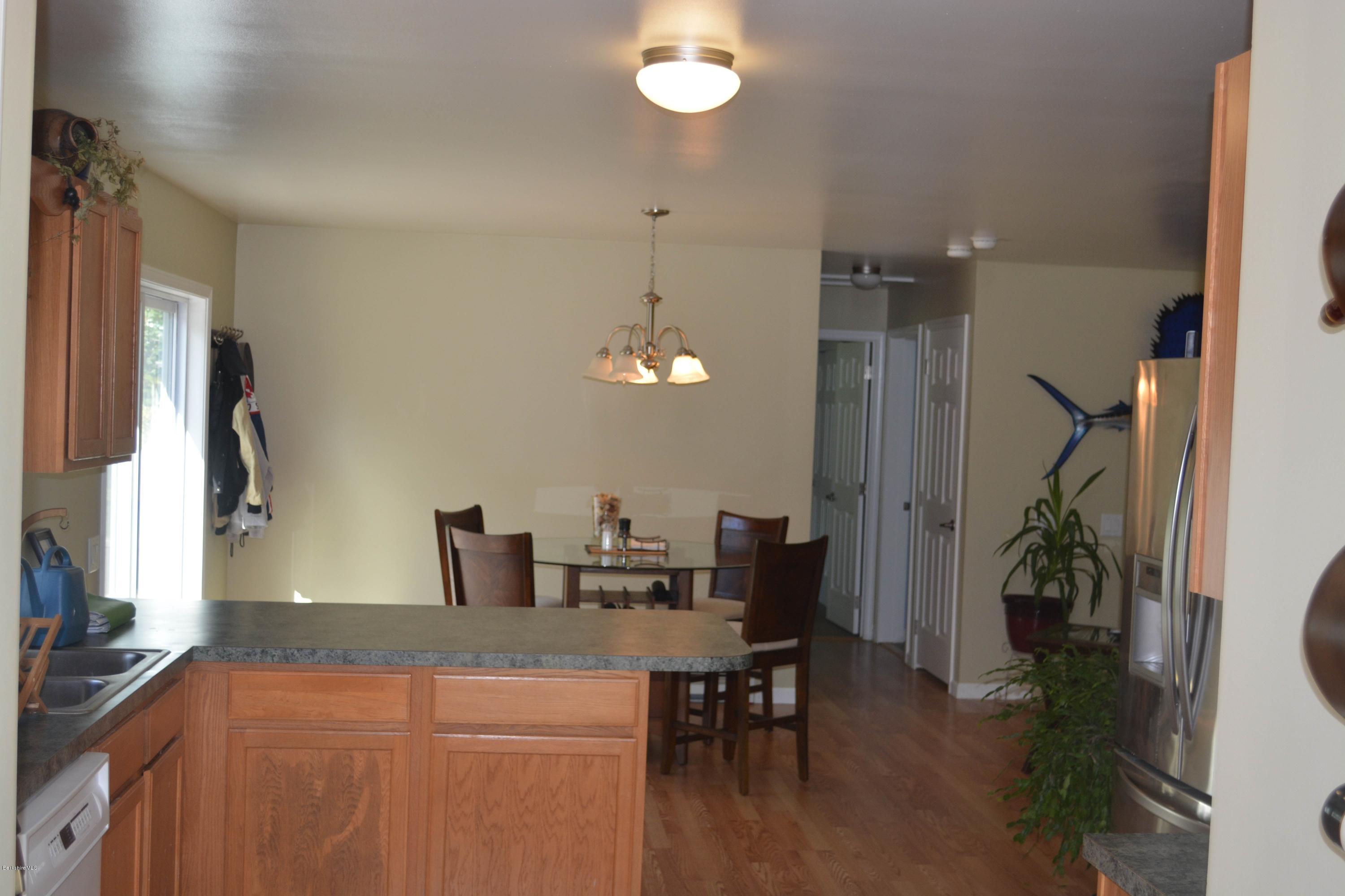 220 Sandisfield Road Sandisfield, MA 01255 - Photo 2 of 30 a kitchen with a table and chairs in it