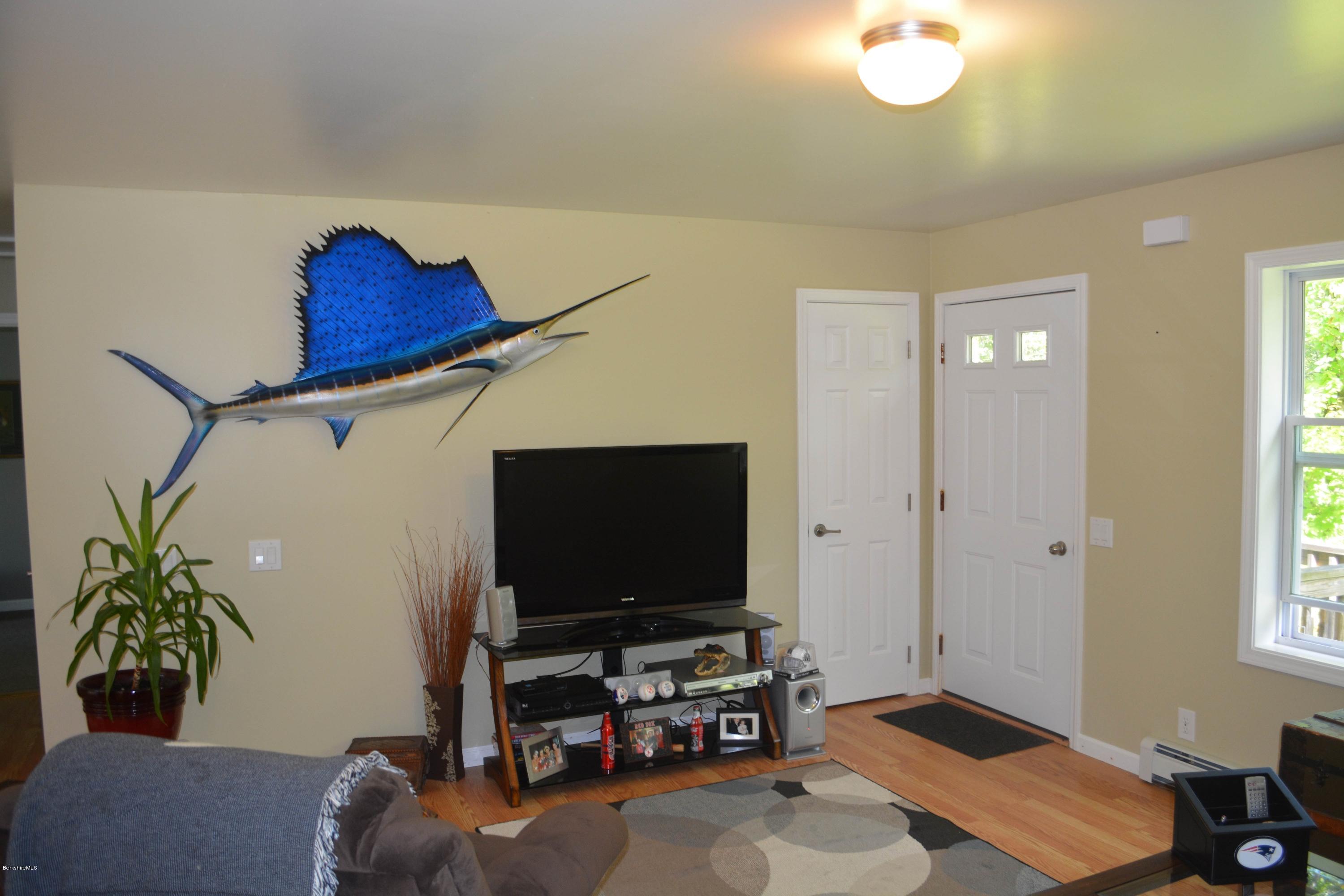 220 Sandisfield Road Sandisfield, MA 01255 - Photo 11 of 30 a living room with furniture and a flat screen tv