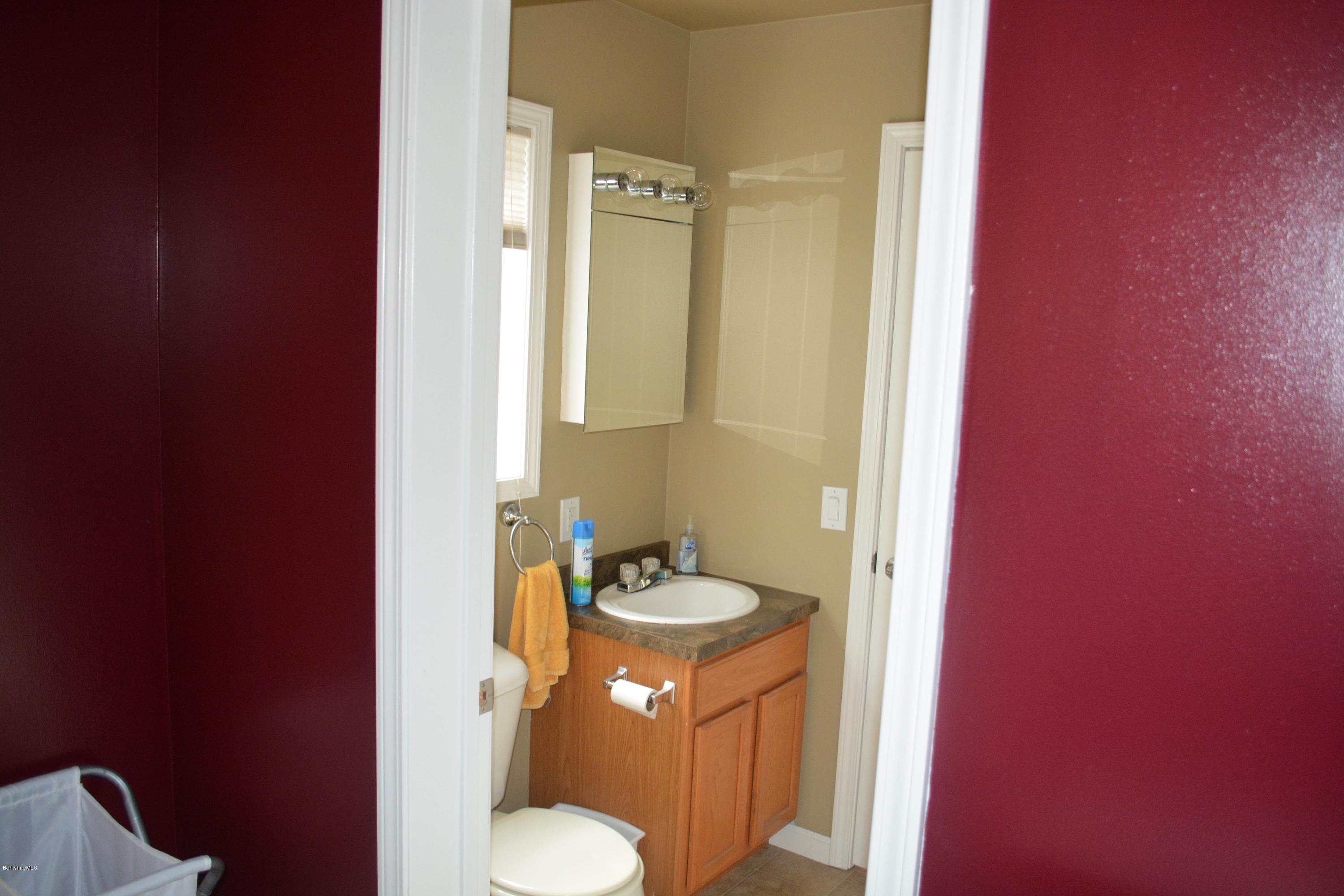 220 Sandisfield Road Sandisfield, MA 01255 - Photo 13 of 30 a bathroom with a granite countertop sink toilet and shower