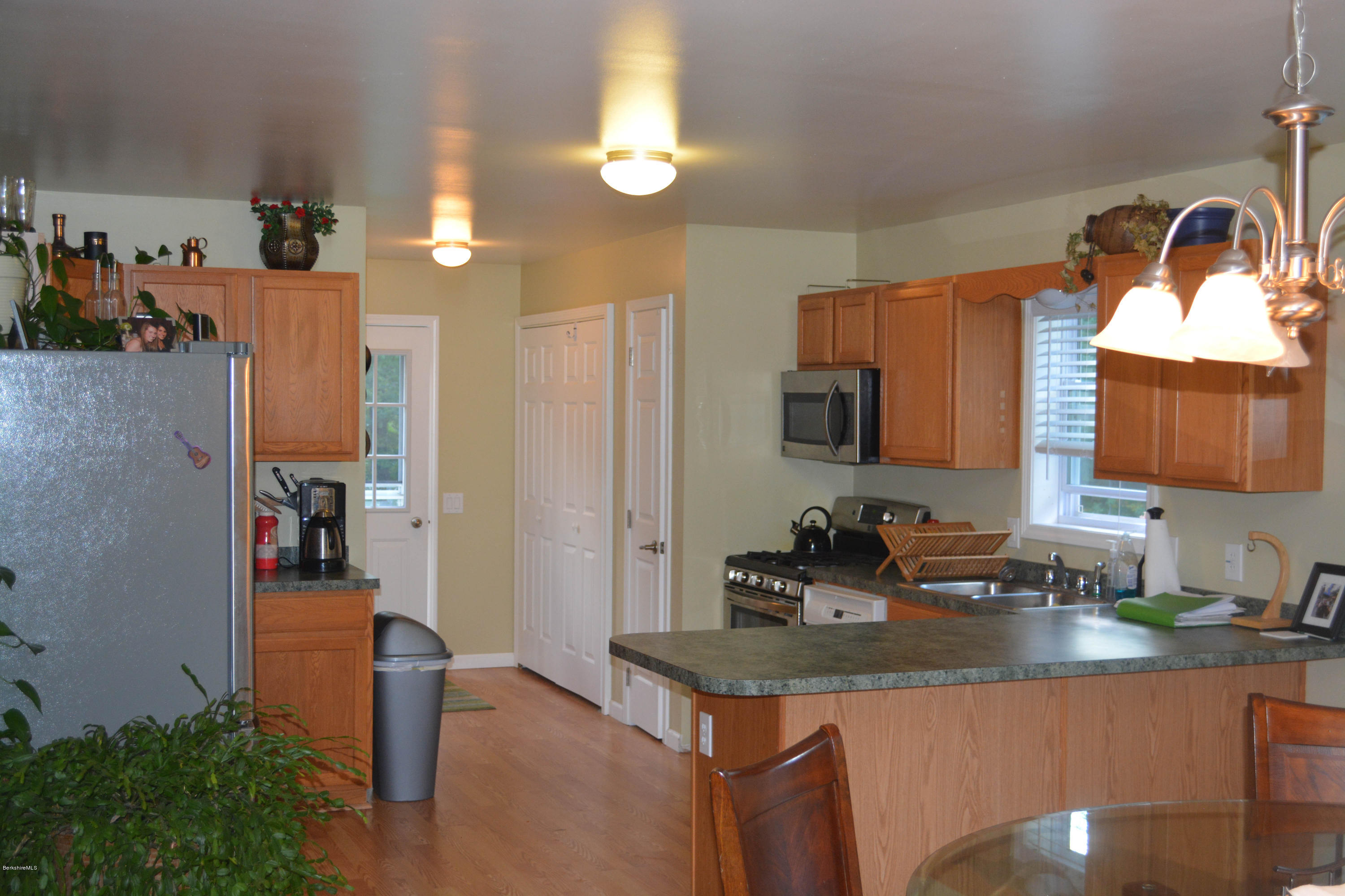 220 Sandisfield Road Sandisfield, MA 01255 - Photo 3 of 30 a kitchen with sink a refrigerator and cabinets