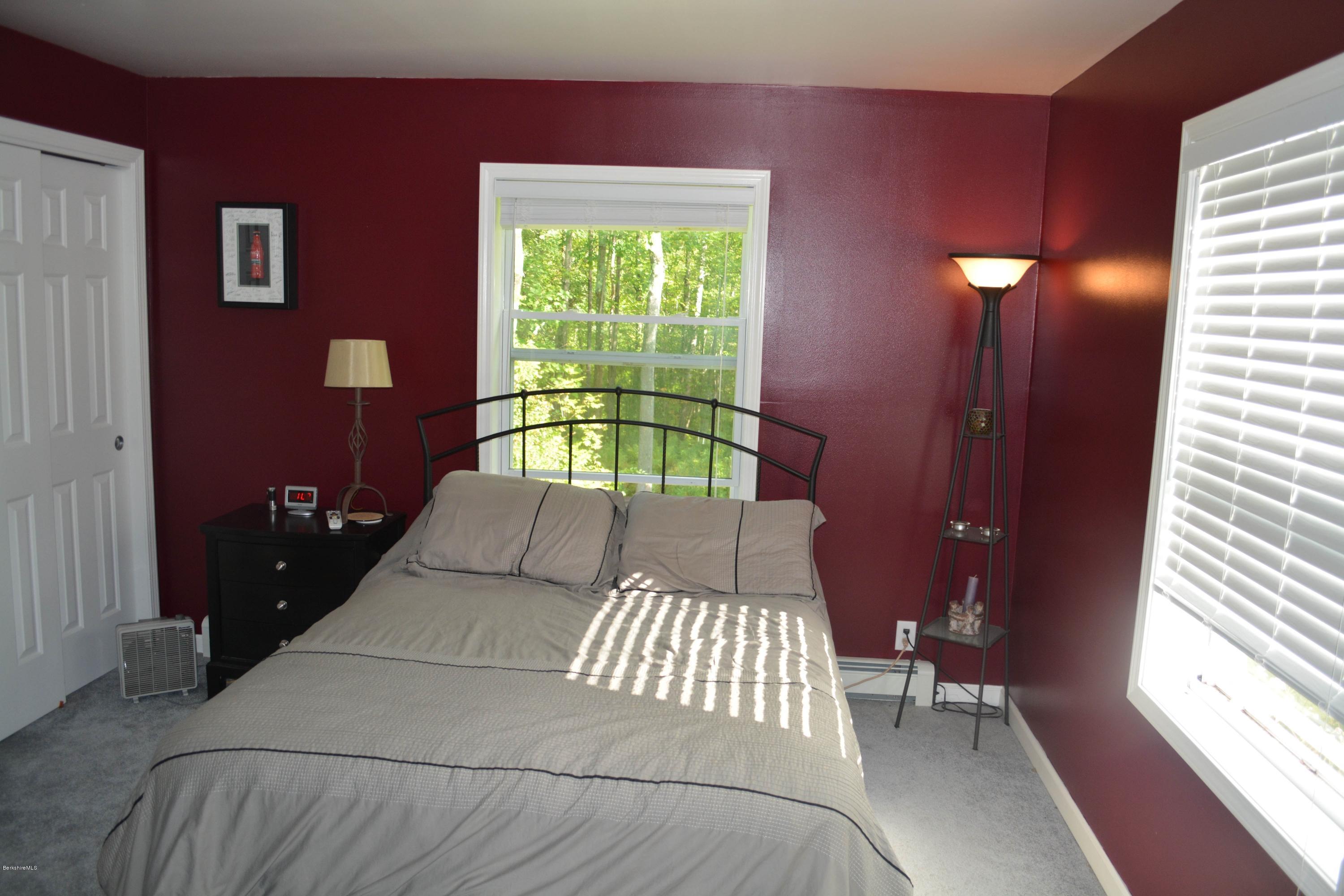 220 Sandisfield Road Sandisfield, MA 01255 - Photo 8 of 30 a bed sitting in a bedroom next to a window
