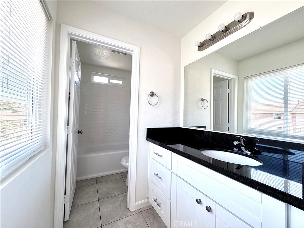 417 North Grove Avenue, Unit A Ontario, CA 91764 - Photo 11 of 17 a bathroom with a sink and a mirror