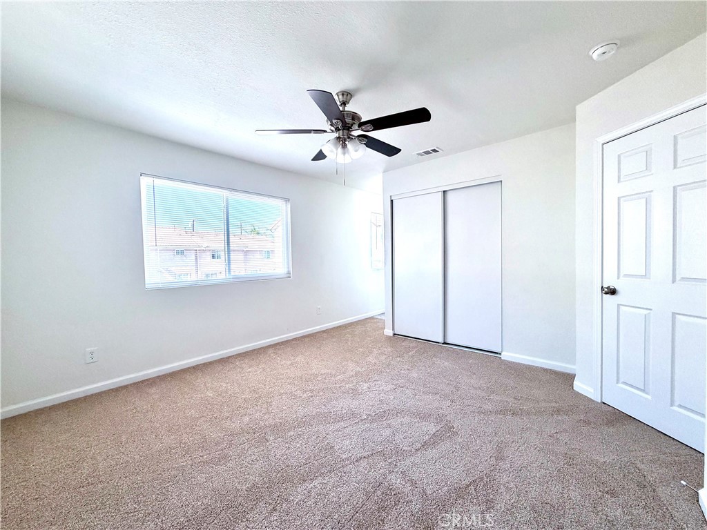 417 North Grove Avenue, Unit A Ontario, CA 91764 - Photo 12 of 17 an empty room with windows and fan