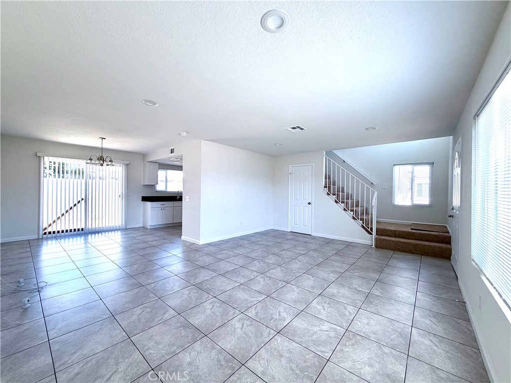 417 North Grove Avenue, Unit A Ontario, CA 91764 - Photo 3 of 17 a view of empty room with wooden floor and windows