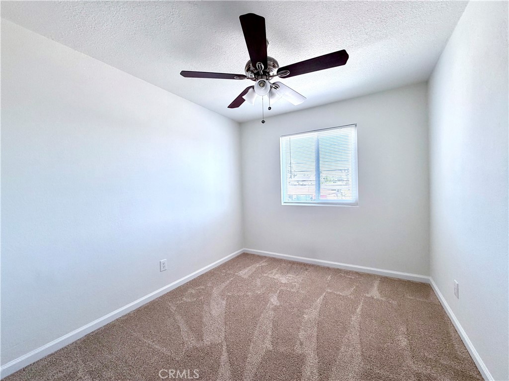 417 North Grove Avenue, Unit A Ontario, CA 91764 - Photo 7 of 17 an empty room with windows and fan