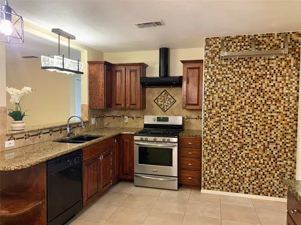 a view of a hallway with a dining table and chairs