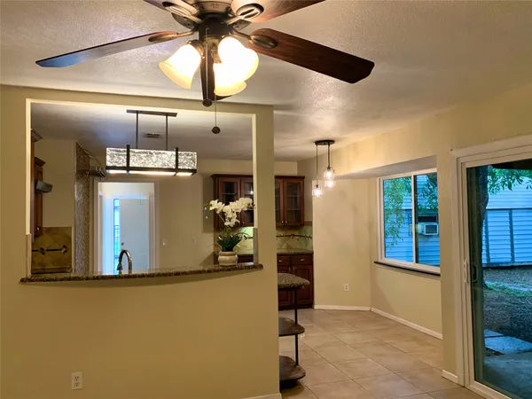 a view of a room that has a bed and a table in it