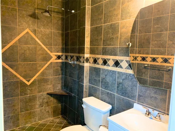 a bathroom with a toilet and shower