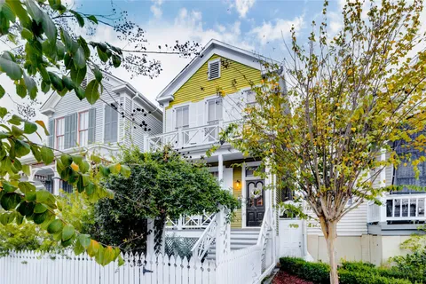 a aerial view of a house with a tree in front