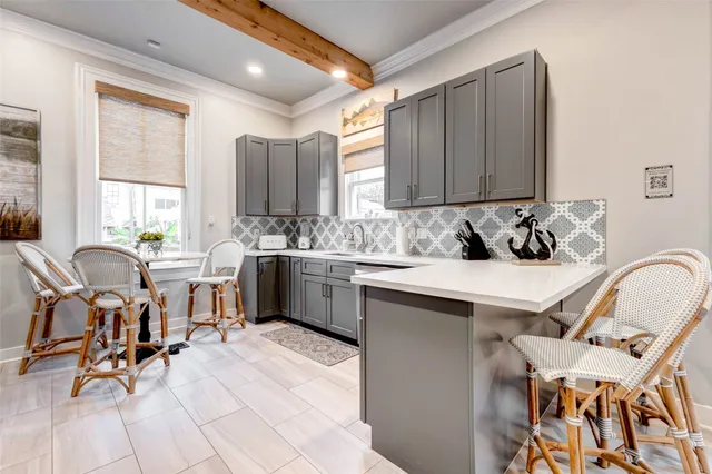 a kitchen with stainless steel appliances granite countertop a stove a sink a dining table and chairs