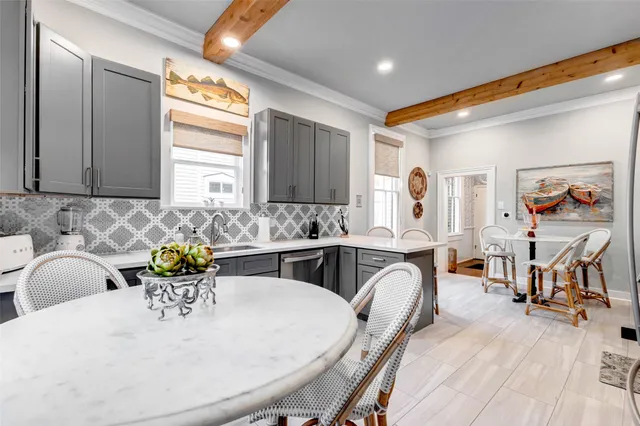 a kitchen with stainless steel appliances a sink dishwasher stove refrigerator and cabinets