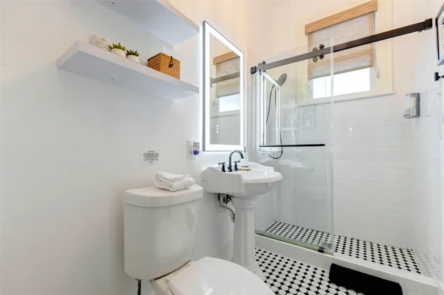 a bathroom with a sink toilet and shower