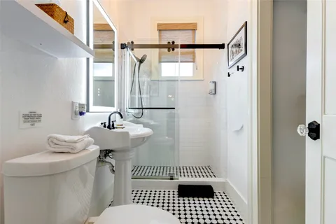a bathroom with a sink a mirror and a shower