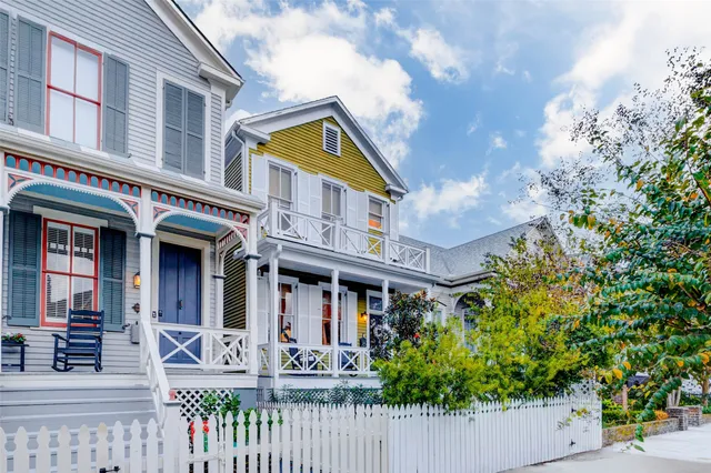 front view of a brick house with large windows