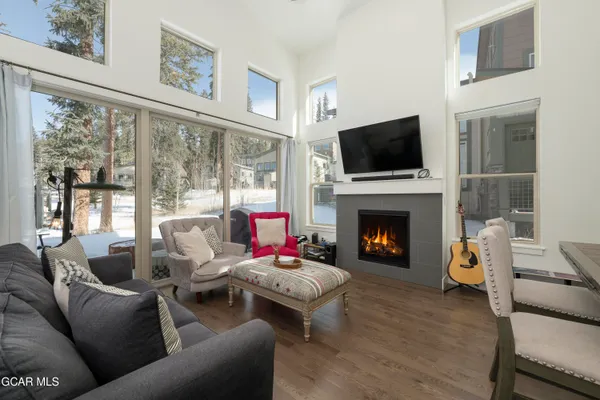 a living room with furniture a flat screen tv and a fireplace