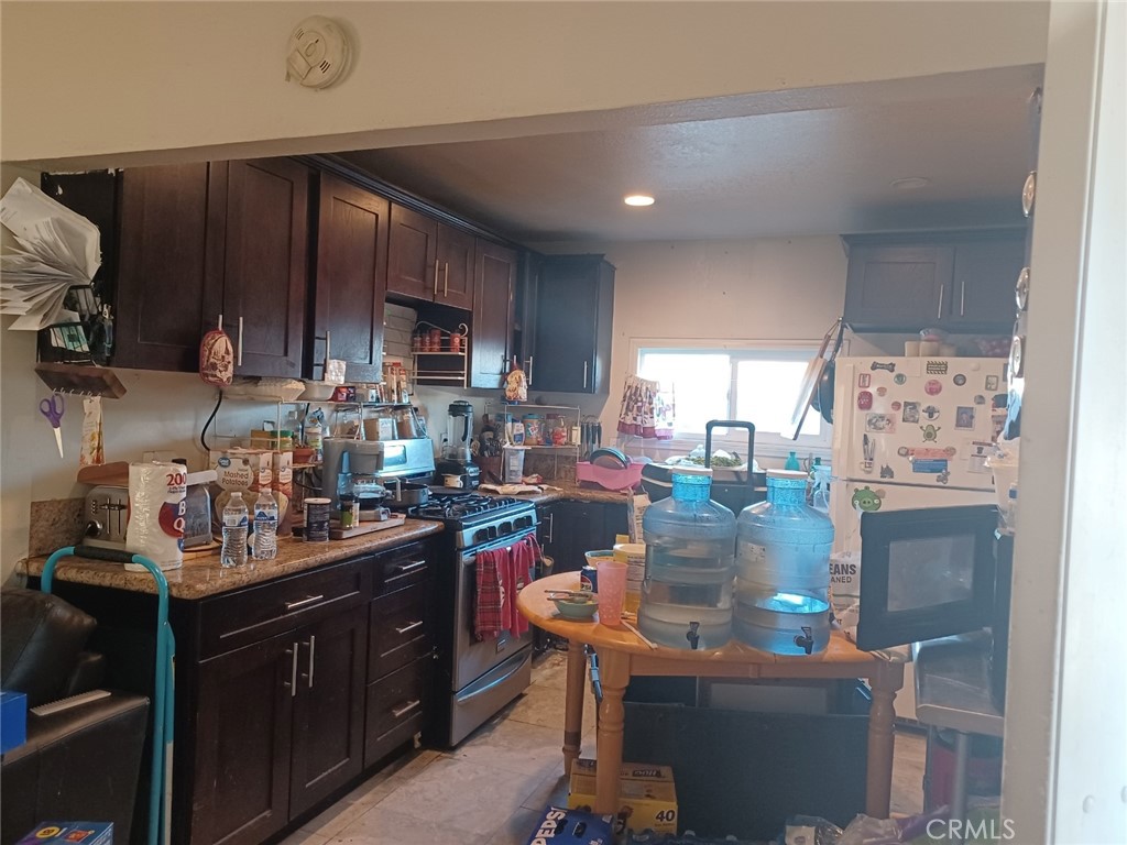 25508 Paloma Road Highland, CA 92410 - Photo 16 of 17 a kitchen with a sink cabinets and window