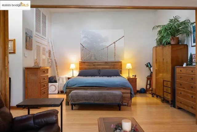 a bedroom with a bed and a potted plant