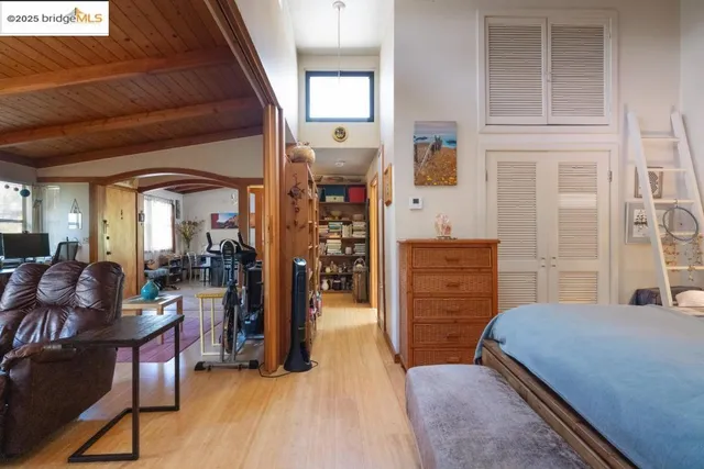 a bedroom with furniture and wooden floor
