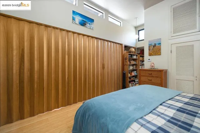 a bedroom with a bed and a curtain