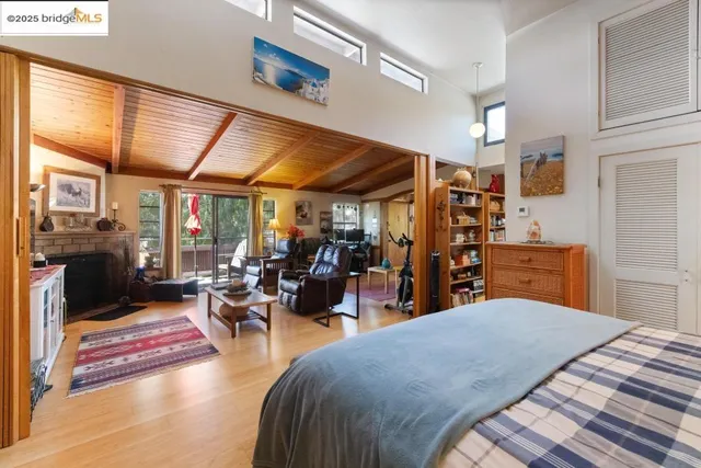 a bedroom with bed and glass windows