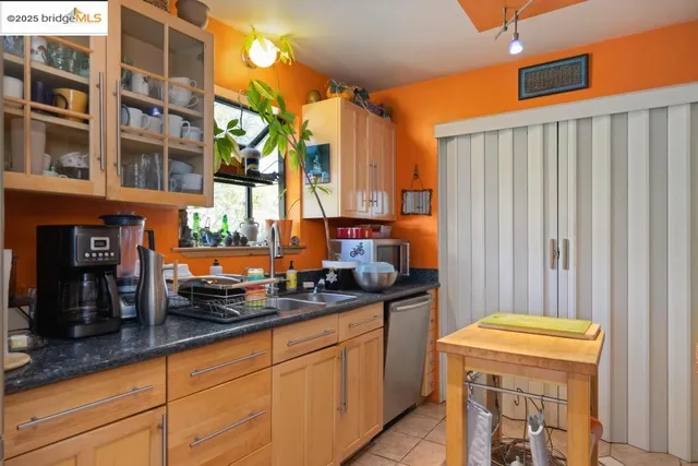 a kitchen with stainless steel appliances granite countertop sink stove and refrigerator
