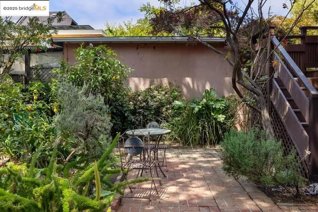 a front view of a house with a tree