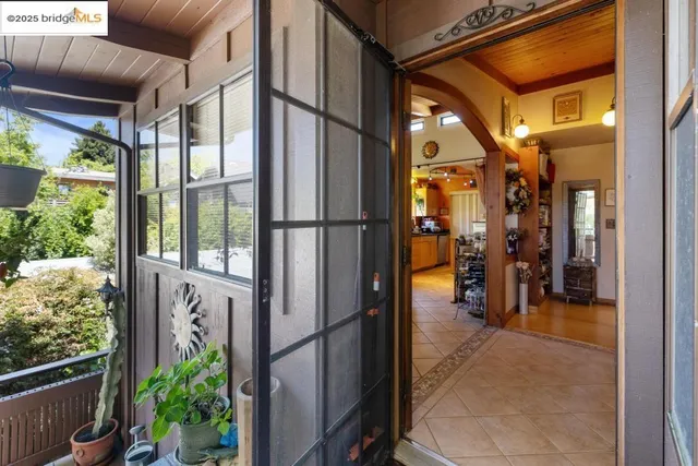 a view of a living room filled with furniture and a window