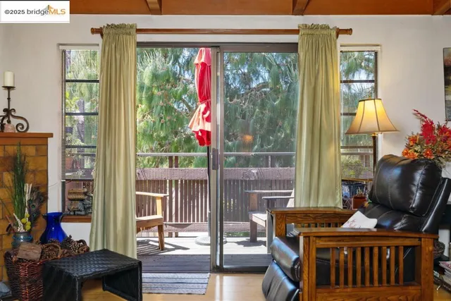 a living room with furniture and a floor to ceiling window