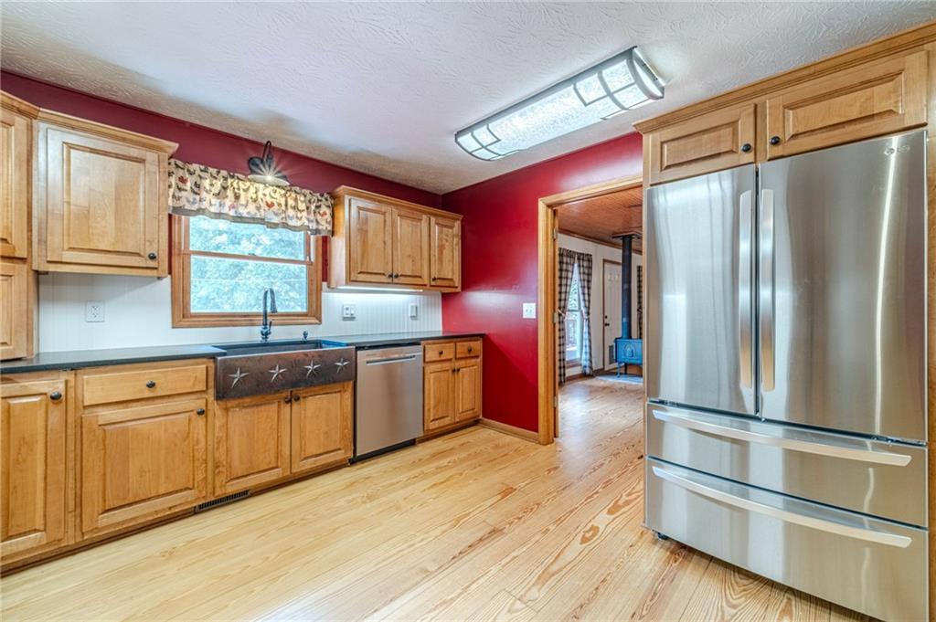 317 Duncan Road Oxford, GA 30054 - Photo 14 of 48 a kitchen with stainless steel appliances granite countertop a refrigerator a sink and a stove