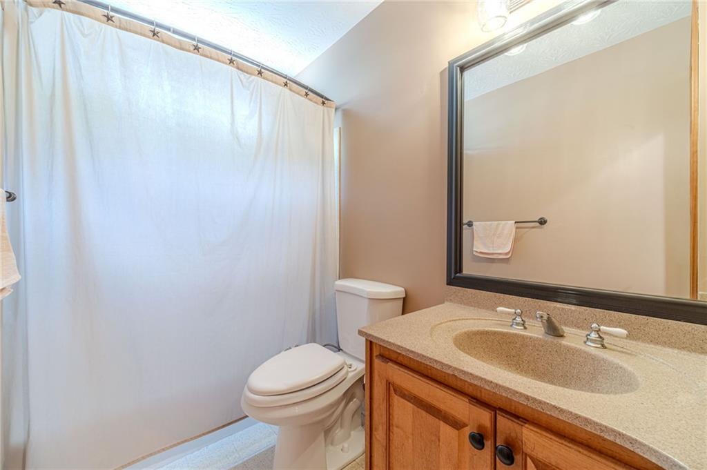 317 Duncan Road Oxford, GA 30054 - Photo 28 of 48 a bathroom with a granite countertop sink toilet and a mirror