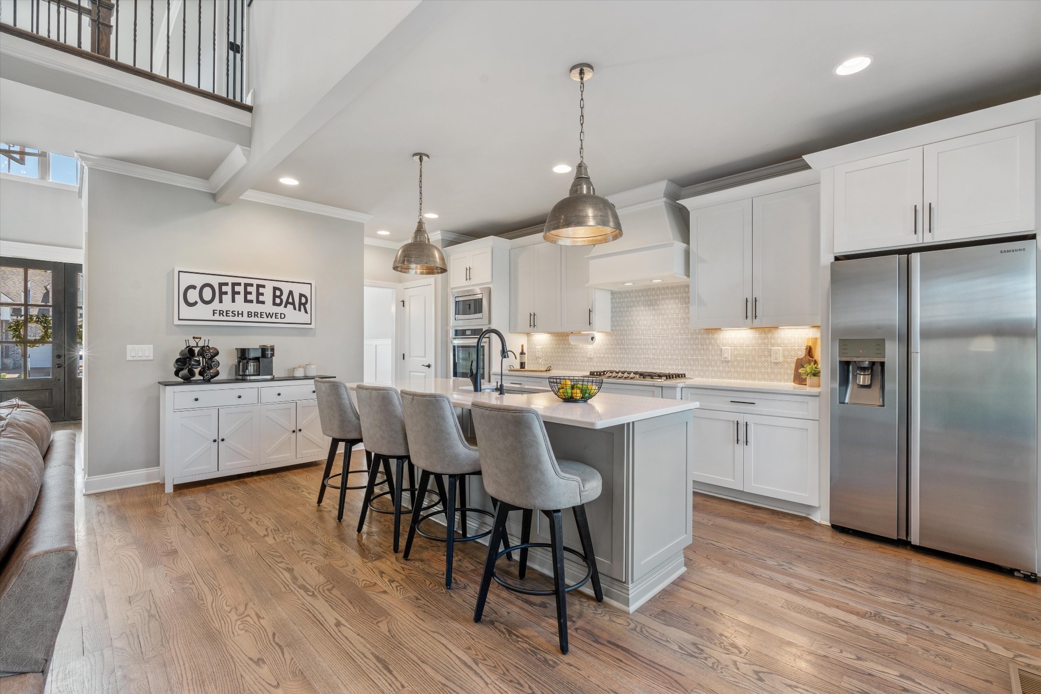 1706 Sorrell Pk Drive Spring Hill, TN 37174 - Photo 4 of 50 a kitchen with stainless steel appliances a table chairs wooden floors and a view of living room
