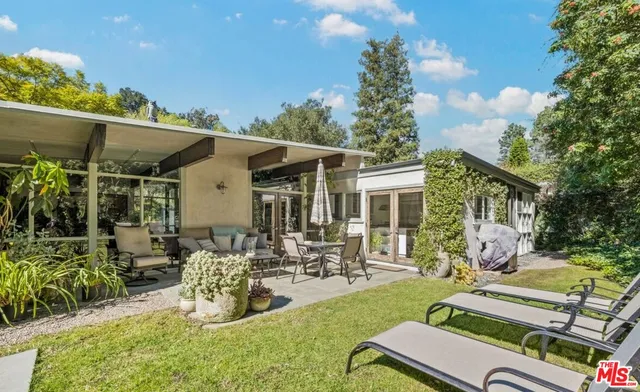 a front view of house with a garden and patio