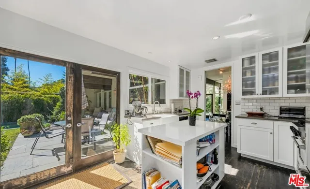 a open kitchen with granite countertop a sink stove and cabinets