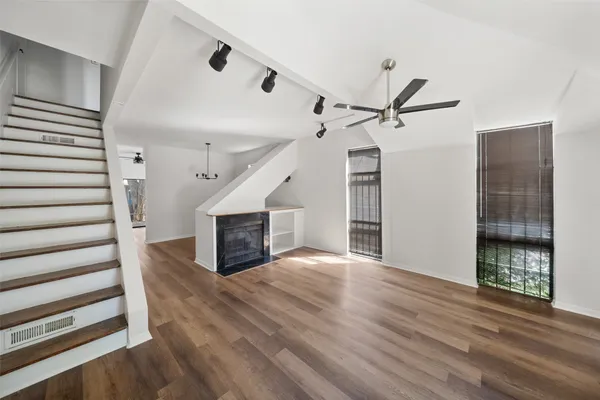 wooden floor in an empty room with a fireplace