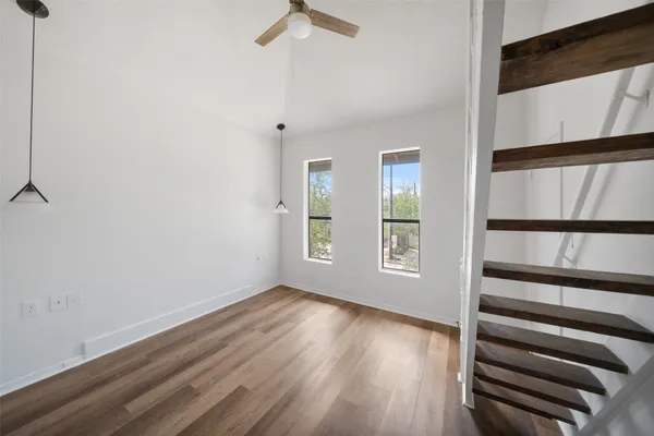 a view of a room with wooden floor