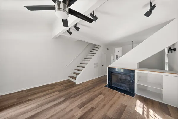a view of entryway and hall with wooden floor