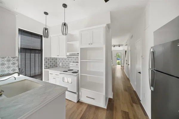 a kitchen with a refrigerator a sink and dishwasher